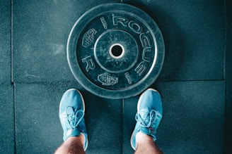 person standing beside black weights