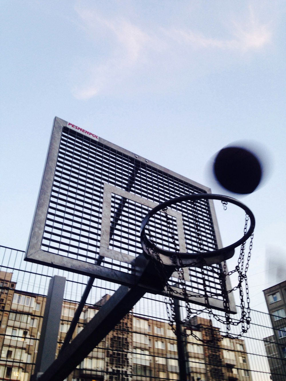 gray and black basketball hoop and backboard at daytime