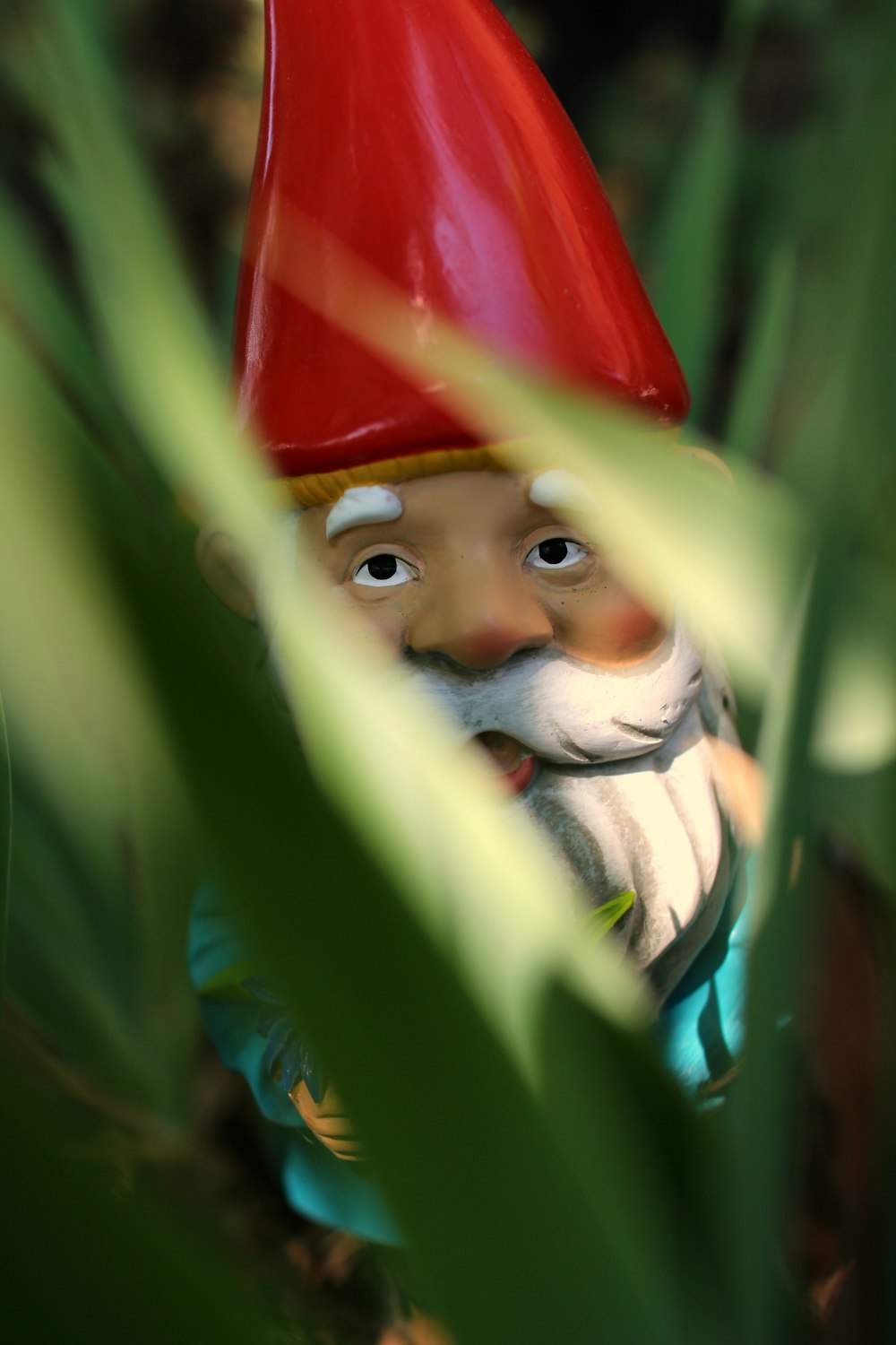 gnome standing on green grass during daytime