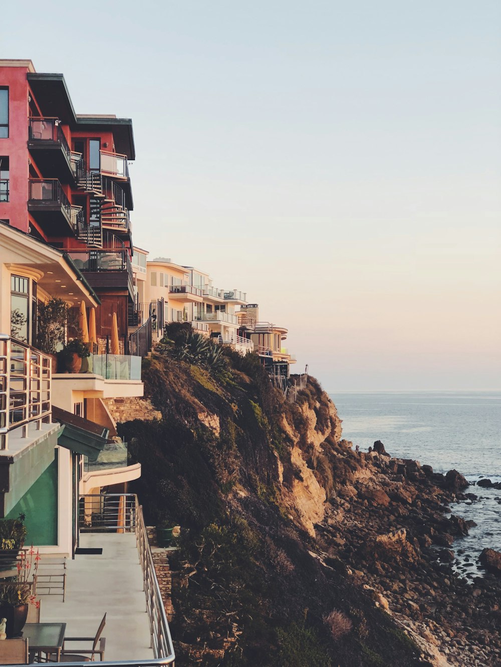 village on cliff under blue sky