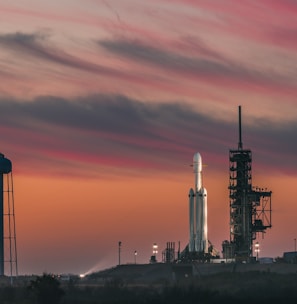 white rocket under nimbus clouds at golden hour