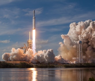 gray spacecraft taking off during daytime