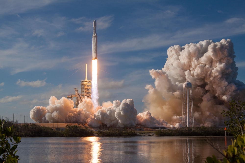 gray spacecraft taking off during daytime