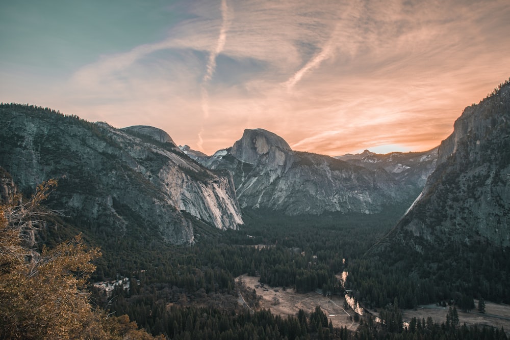 Berge umgeben von Bäumen während der goldenen Stunde