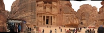 A vibrant market scene in Petra with ancient rock-cut architecture in the background.