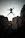 person jumping on big rock under gray and white sky during daytime