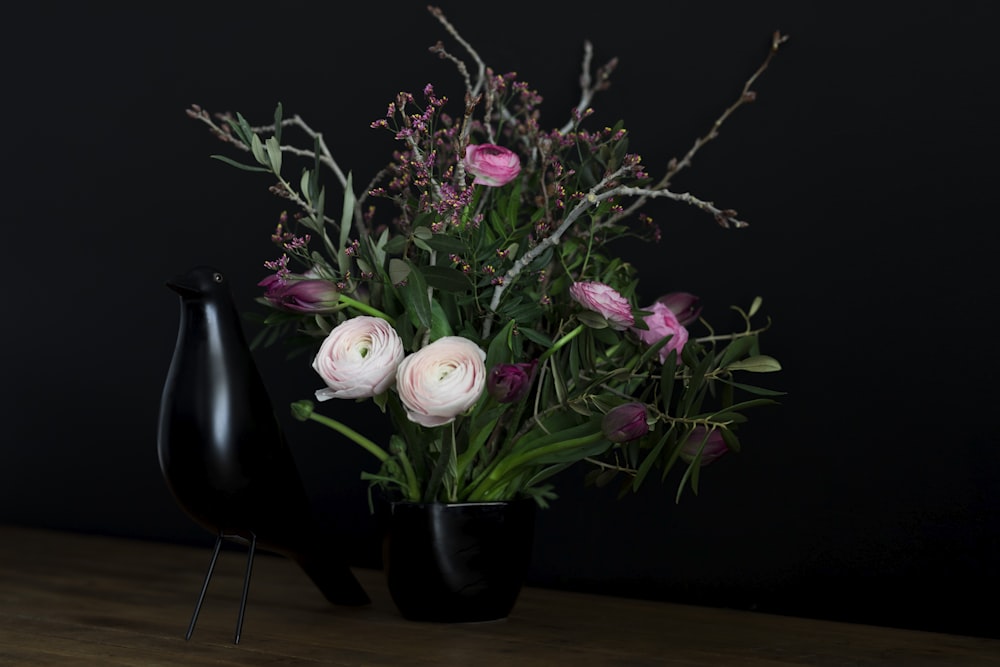 weiße und rosa Blumen mit schwarzer Vase