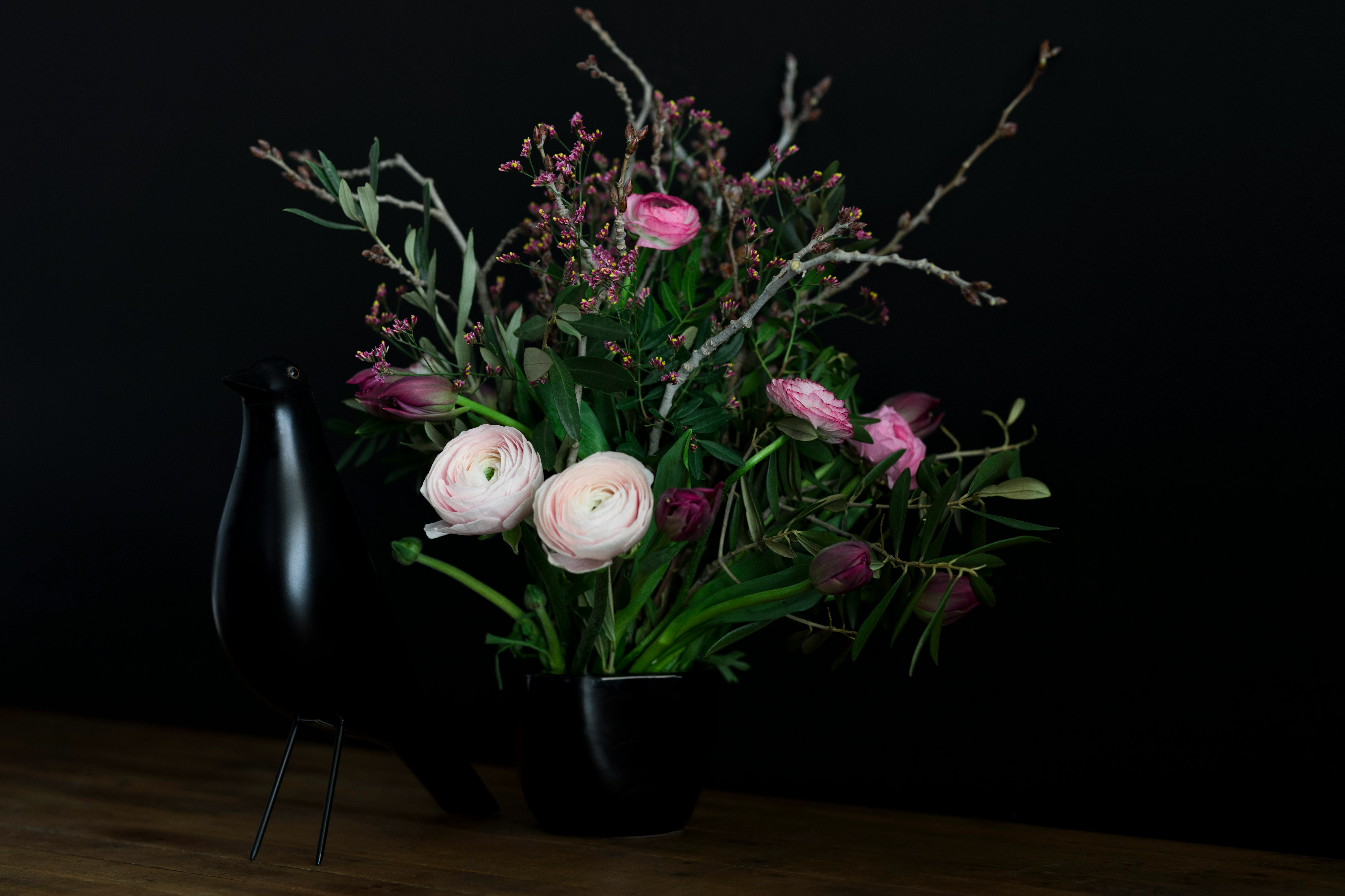 white and pink flowers with black vase