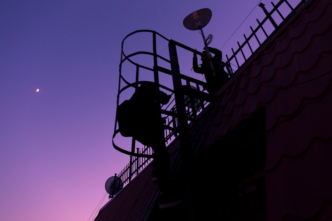 silhouette of person climbing ladder