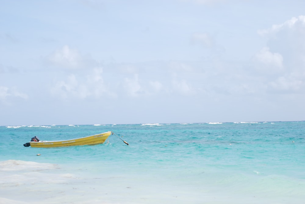 yellow boat on body of water photo