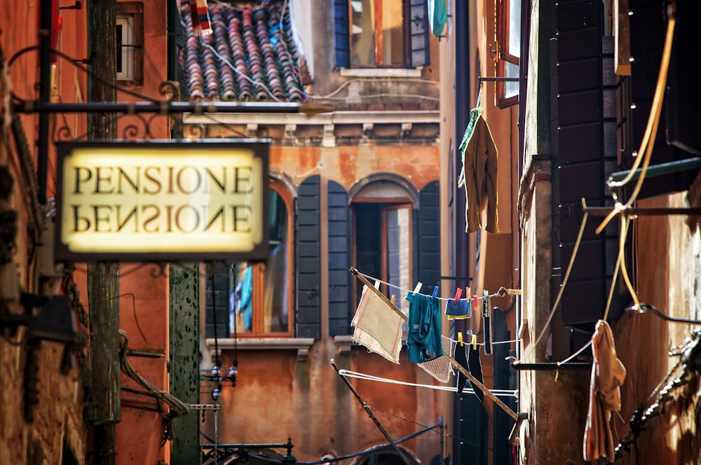 pensione signage near brown concrete building