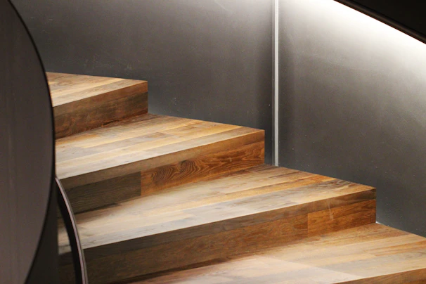 A rustic wooden staircase crafted by Holzgeist, highlighting smooth curves and sturdy construction.