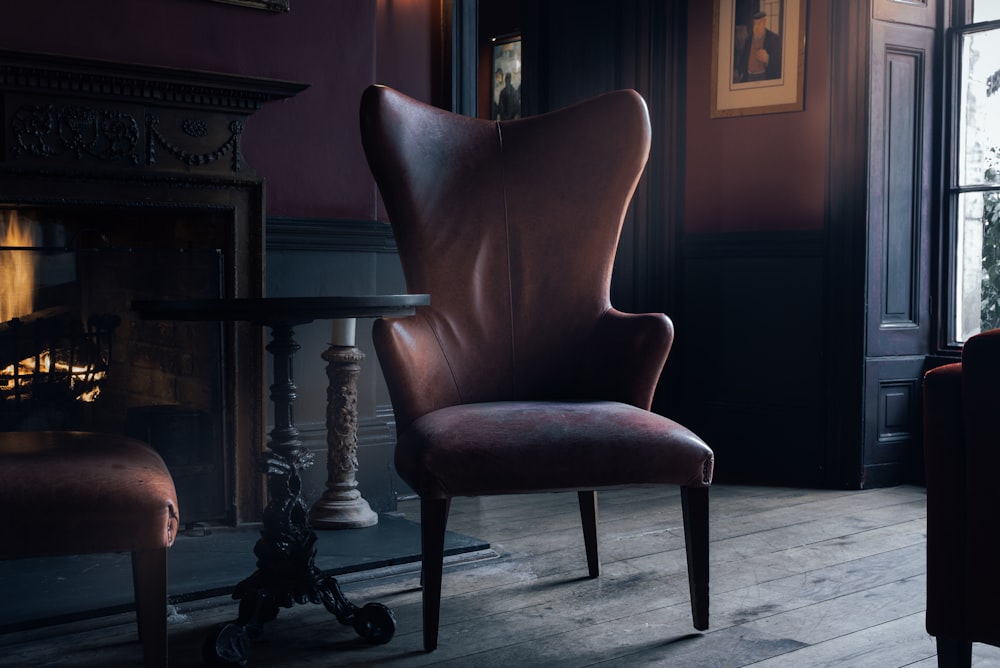 brown fabric seat near brown wooden pedestal table