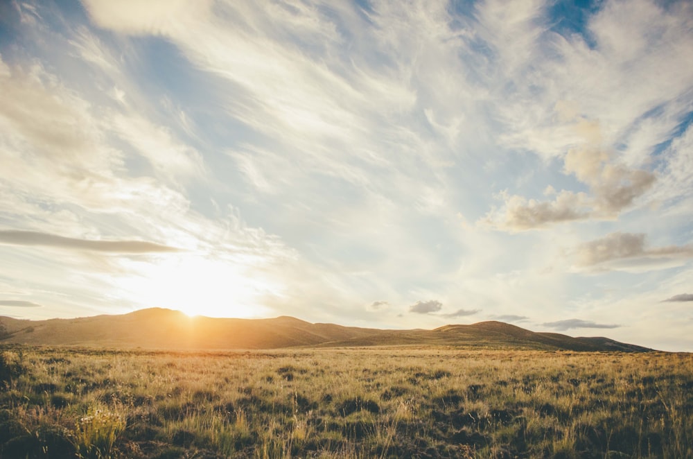 landscape photography of mountains in front of green grass field during daytime