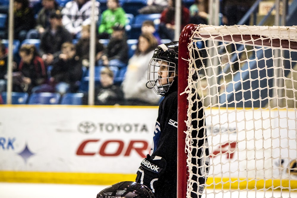 ice hockey player near goal net