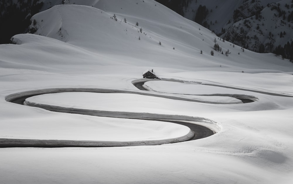 a winding road in the middle of a snow covered mountain