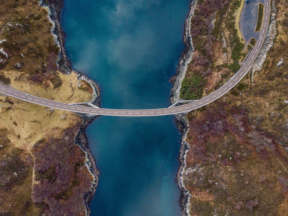 high angle photography of concrete road connecting two lands