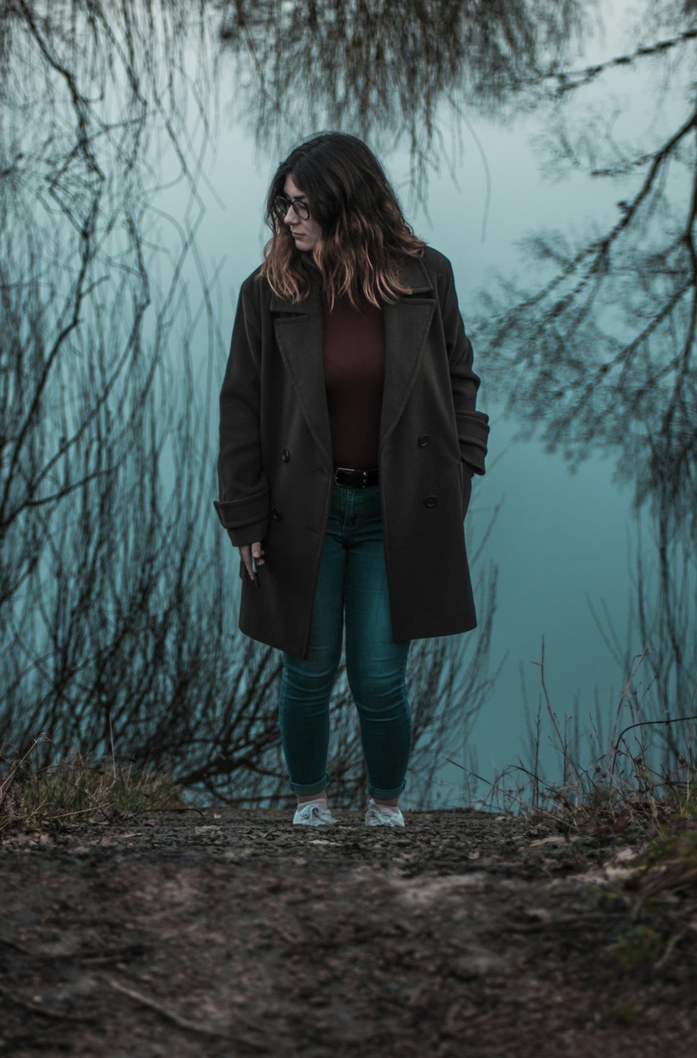 woman walking near withered plants