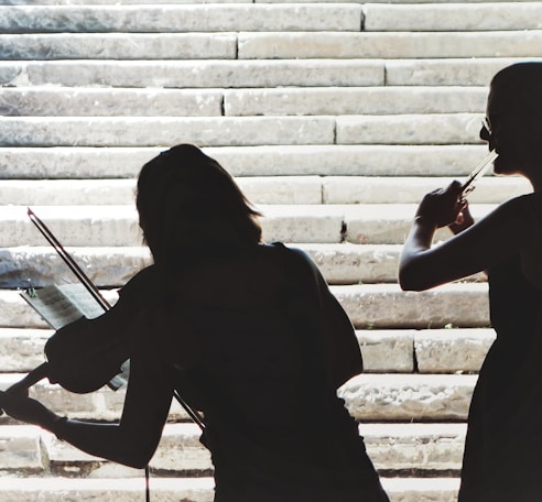 two women playing violin and flute