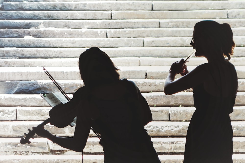 two women playing violin and flute