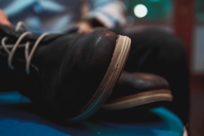 Close-up of a customer trying on comfortable leather shoes with a smile.
