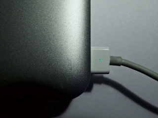 A close-up of a technician remotely resolving a network issue on a laptop.