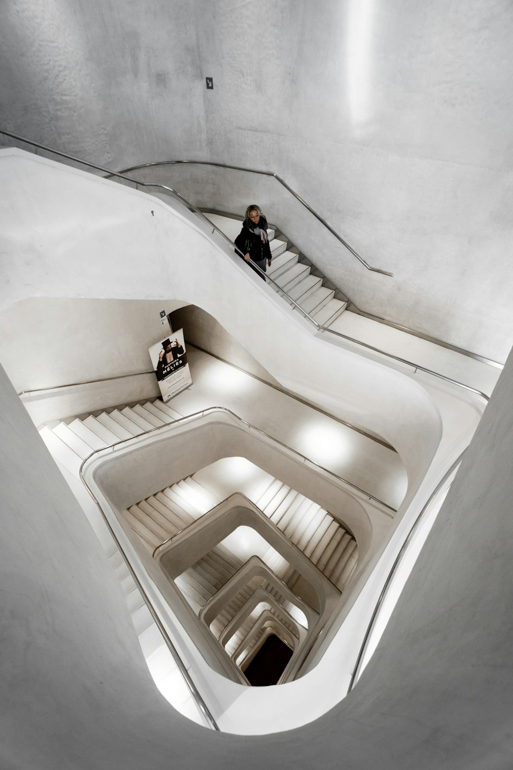 person walking downstairs inside the building