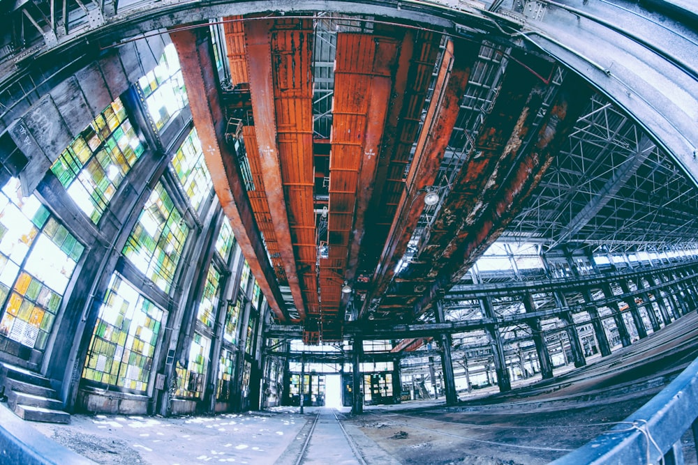 fish lens photography of black and red building interior