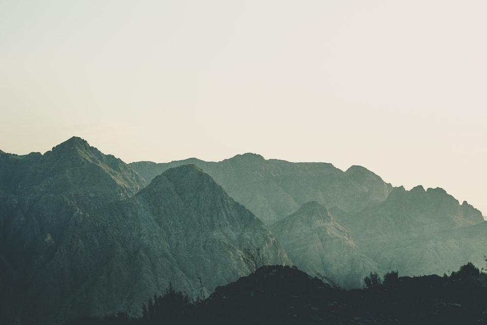 black and white mountains under white sky