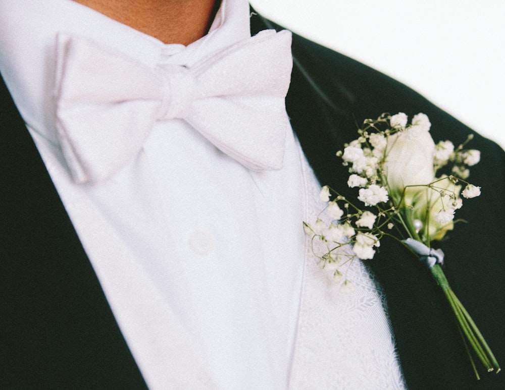 white petaled flower on man's lapel