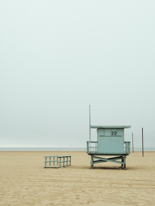 teal lifeguard shed near beach at daytime in Santa Monica Beach United States
