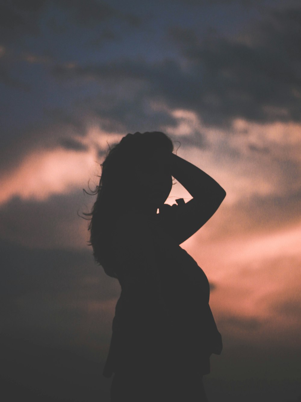 silhouette of woman holding his hair