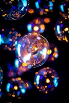 Soft glowing orbs floating in a dark, cosmic environment.