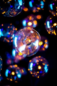 Soft glowing orbs of pink, blue, and purple light surrounding a peaceful figure.