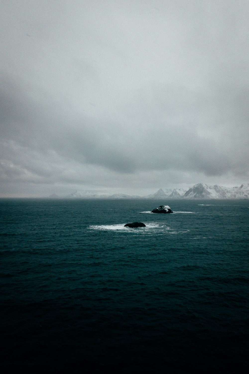 blue sea water under white clouds