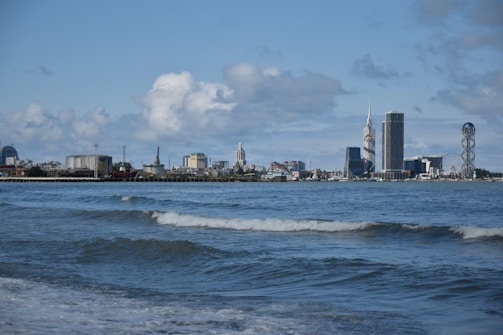 Coastal city skyline with rising sea levels visible at waterfront.