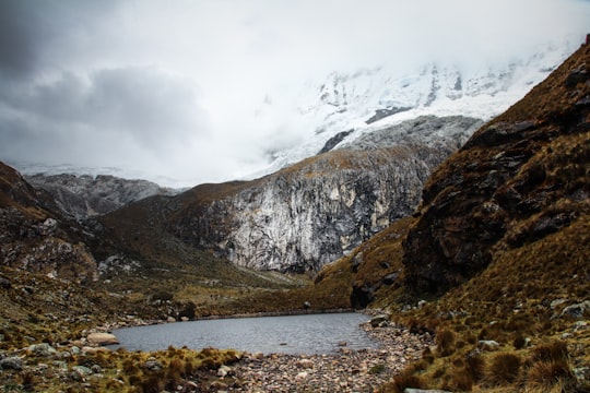 body of water near mountain at daytime in Laguna 69 Peru