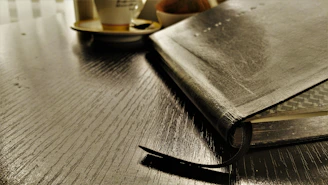 A sleek leather-bound notebook and pen set, perfect for jotting down picks and insights during the game.