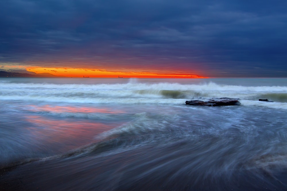 photo panoramique timelapse de la mer pendant l’heure dorée