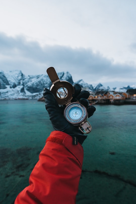 round gray compass in Lofoten Islands Norway