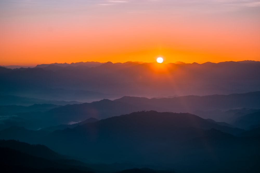 fog covering mountain during golden hour