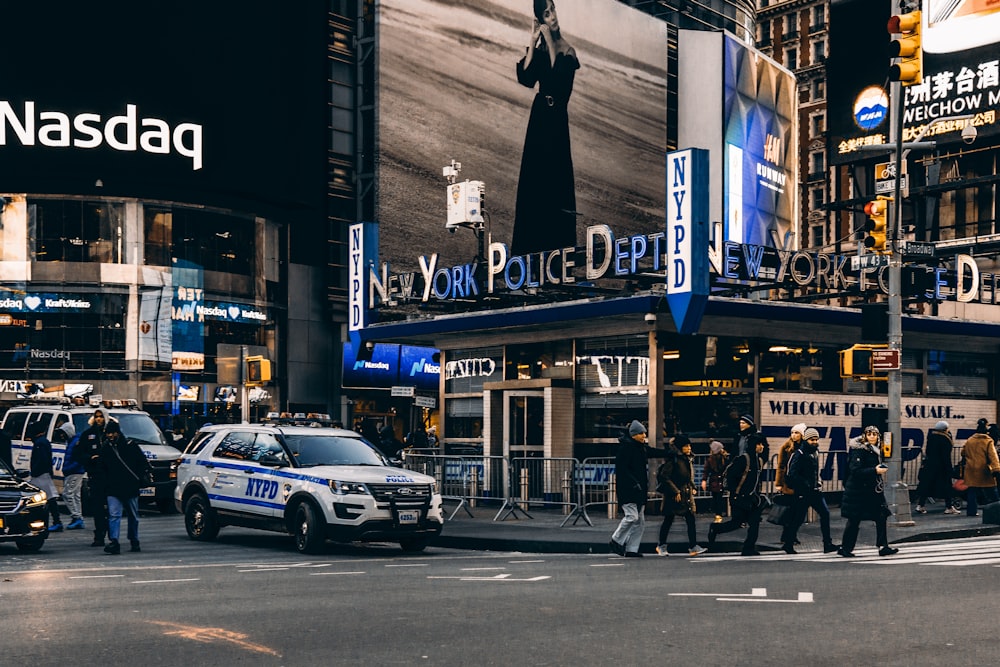 people walking on pedestrian lane near vehicles