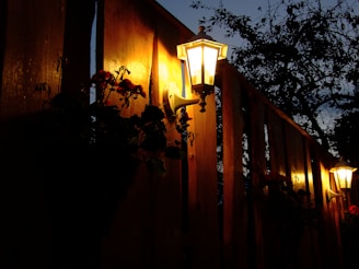 Evening view of a well-lit fence highlighting the clean lines and craftsmanship.