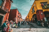 A vibrant street scene in Oaxaca showcasing colorful buildings and local culture.