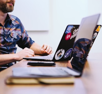 man sitting in front of laptop