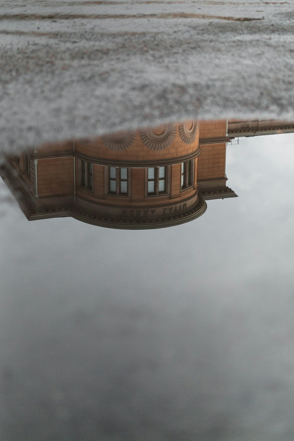 water mirror of brown commercial building