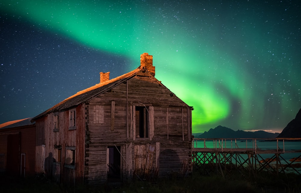 brown wooden house near body of water