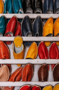 assorted-color shoe lot on white wooden shelf