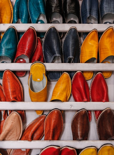 assorted-color shoe lot on white wooden shelf