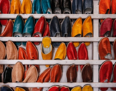 assorted-color shoe lot on white wooden shelf